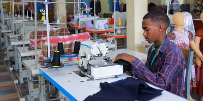 A young student learning sewing skills, developing practical vocational expertise for the future