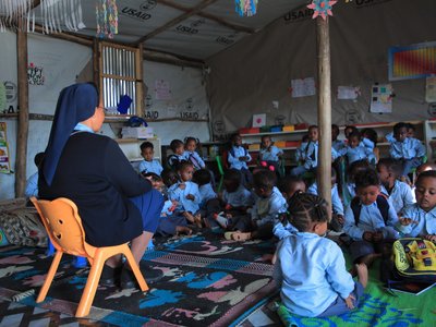 Sister Teaches Children in Temporary Classroom